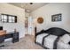 Comfortable bedroom with a ceiling fan, and a closet with a door to the Primary bath at 8024 W Vista Ave, Glendale, AZ 85303