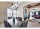 Formal dining area with a modern chandelier and comfortable upholstered chairs at 8024 W Vista Ave, Glendale, AZ 85303