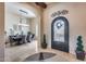 Inviting entryway with arched doorway, decorative metal art, and travertine flooring at 8024 W Vista Ave, Glendale, AZ 85303