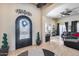 Grand entryway featuring decorative wrought iron door and views to the living room at 8024 W Vista Ave, Glendale, AZ 85303