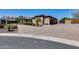 Elegant home exterior featuring a circular driveway, desert landscaping, and a gated entrance for added privacy at 8024 W Vista Ave, Glendale, AZ 85303