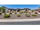 Beautiful single-Gathering home with a stone facade, manicured landscaping, and a circular driveway at 8024 W Vista Ave, Glendale, AZ 85303