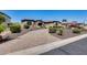 Beautiful home showcasing a circular driveway, lush landscaping, and an inviting facade with stone accents at 8024 W Vista Ave, Glendale, AZ 85303