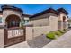 Charming home entrance featuring a gated courtyard, stone accents, and a welcoming front door at 8024 W Vista Ave, Glendale, AZ 85303