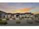 Beautiful single-story home with manicured landscaping and a stone-accented facade under a dramatic sunset sky at 8024 W Vista Ave, Glendale, AZ 85303