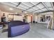 Well-organized garage with storage cabinets, car cover, epoxy floors, and convenient access at 8024 W Vista Ave, Glendale, AZ 85303