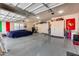 Spacious garage with epoxy floors, car cover, ample storage, and room for hobbies and projects at 8024 W Vista Ave, Glendale, AZ 85303
