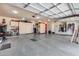 Clean garage with epoxy floors, storage, organization, and room for vehicles or hobbies at 8024 W Vista Ave, Glendale, AZ 85303