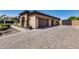 Garage with stone detailing, multi-car capacity and a paved driveway complemented by manicured landscaping at 8024 W Vista Ave, Glendale, AZ 85303