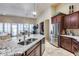 Spacious kitchen with granite countertops, stainless appliances, and seamless access to both the dining and living areas at 8024 W Vista Ave, Glendale, AZ 85303
