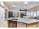 Open concept kitchen featuring granite island and stainless steel sink at 8024 W Vista Ave, Glendale, AZ 85303