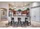 Gourmet kitchen with large island, seating, stainless steel appliances, and pendant lighting at 8024 W Vista Ave, Glendale, AZ 85303