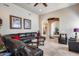 Spacious living area with a large leather sectional and access to other rooms at 8024 W Vista Ave, Glendale, AZ 85303
