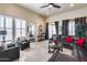 Inviting living room with tile flooring, plantation shutters, and comfortable leather furniture at 8024 W Vista Ave, Glendale, AZ 85303