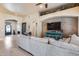 Open living space with neutral-toned sectional sofa and brick accent wall, seamlessly blending into the entryway at 8024 W Vista Ave, Glendale, AZ 85303