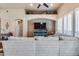 Cozy living room showcases brick wall accents, built-in shelving, and a spacious sectional sofa for ultimate relaxation at 8024 W Vista Ave, Glendale, AZ 85303