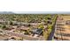 This aerial shot features the neighborhood, lush green trees, desert landscape, and mountain views at 8730 E Montecito Ave, Scottsdale, AZ 85251
