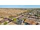 Aerial view captures houses near desert terrain, showcasing community living and natural landscapes at 8730 E Montecito Ave, Scottsdale, AZ 85251