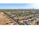 Wide aerial shot of the community featuring houses, streets, and a mountain range in the distance at 8730 E Montecito Ave, Scottsdale, AZ 85251