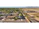 This aerial shot features lush green trees, the neighborhood, and the home's proximity to desert landscape at 8730 E Montecito Ave, Scottsdale, AZ 85251