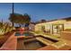 Beautiful backyard showcasing a pool, spa, covered patio, and lush greenery at 8730 E Montecito Ave, Scottsdale, AZ 85251