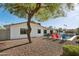 A charming backyard with a shimmering pool, inviting lounge chairs, and mature landscaping at 8730 E Montecito Ave, Scottsdale, AZ 85251