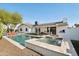 Relaxing backyard featuring a sparkling pool, hot tub, outdoor dining area, and a built-in grill at 8730 E Montecito Ave, Scottsdale, AZ 85251