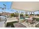 Backyard featuring a patio, outdoor kitchen with a built-in grill, pool, hot tub, cactus landscaping, and palm trees at 8730 E Montecito Ave, Scottsdale, AZ 85251