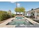 Lush backyard with a refreshing pool, hot tub, and plenty of lounge seating, surrounded by desert landscaping at 8730 E Montecito Ave, Scottsdale, AZ 85251