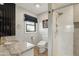 Stylish bathroom featuring walk-in shower, granite countertops, and dark accents at 8730 E Montecito Ave, Scottsdale, AZ 85251