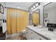 Bathroom features double sinks, granite countertops, black accents and a shower/tub combo at 8730 E Montecito Ave, Scottsdale, AZ 85251
