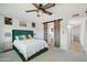 Bright bedroom with large windows, a ceiling fan, and barn door to bathroom at 8730 E Montecito Ave, Scottsdale, AZ 85251