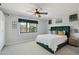 Bright bedroom with large windows, a ceiling fan and an elegant green bed at 8730 E Montecito Ave, Scottsdale, AZ 85251