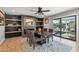 Elegant dining area features a modern ceiling fan, stylish rug, and backyard views, ideal for hosting gatherings at 8730 E Montecito Ave, Scottsdale, AZ 85251