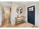 Stylish entryway featuring a modern console table, decorative mirror, and wood-look flooring at 8730 E Montecito Ave, Scottsdale, AZ 85251