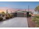 Charming home exterior featuring a modern garage door, desert landscaping, and a well-maintained front yard at 8730 E Montecito Ave, Scottsdale, AZ 85251