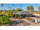 Inviting single-story home with desert landscaping, a modern garage door, and a charming walkway at 8730 E Montecito Ave, Scottsdale, AZ 85251