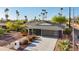 Charming single-story home with a well-manicured lawn, desert landscaping, and a modern two-car garage at 8730 E Montecito Ave, Scottsdale, AZ 85251