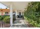 Inviting front porch with lush landscaping, a black iron railing, and stylish architectural details at 8730 E Montecito Ave, Scottsdale, AZ 85251