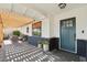 Inviting front porch with stylish seating, lush plants, and a pergola for added curb appeal at 8730 E Montecito Ave, Scottsdale, AZ 85251