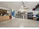 A clean and organized garage space featuring epoxy flooring and lots of shelving and storage cabinets at 8730 E Montecito Ave, Scottsdale, AZ 85251
