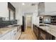 Modern kitchen features stainless steel appliances, white cabinets, and granite countertops at 8730 E Montecito Ave, Scottsdale, AZ 85251
