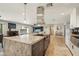 Open kitchen island with granite countertops, stainless hood, and views of the living room and backyard at 8730 E Montecito Ave, Scottsdale, AZ 85251