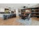 Open-concept kitchen and dining area features a granite island, stainless appliances, and comfortable seating, ideal for gatherings at 8730 E Montecito Ave, Scottsdale, AZ 85251