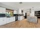 Bright, modern kitchen with white cabinets, black backsplash, granite counters, stainless appliances, and island seating at 8730 E Montecito Ave, Scottsdale, AZ 85251