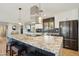 Bright kitchen features stainless appliances, granite countertops, and a large island with seating, perfect for Gathering meals at 8730 E Montecito Ave, Scottsdale, AZ 85251
