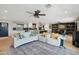 Spacious living room features a modern ceiling fan, stylish rug, and comfortable white couches, perfect for relaxation at 8730 E Montecito Ave, Scottsdale, AZ 85251