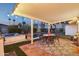 Outdoor patio with a dining set, overhead lights, and desert landscaping, ideal for entertaining at 8730 E Montecito Ave, Scottsdale, AZ 85251