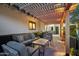 Comfortable outdoor living space with a pergola, cushioned seating, and brick flooring at 8730 E Montecito Ave, Scottsdale, AZ 85251