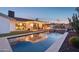 Backyard with a sparkling pool, cozy seating, outdoor kitchen, and lush landscaping, ideal for gatherings at 8730 E Montecito Ave, Scottsdale, AZ 85251